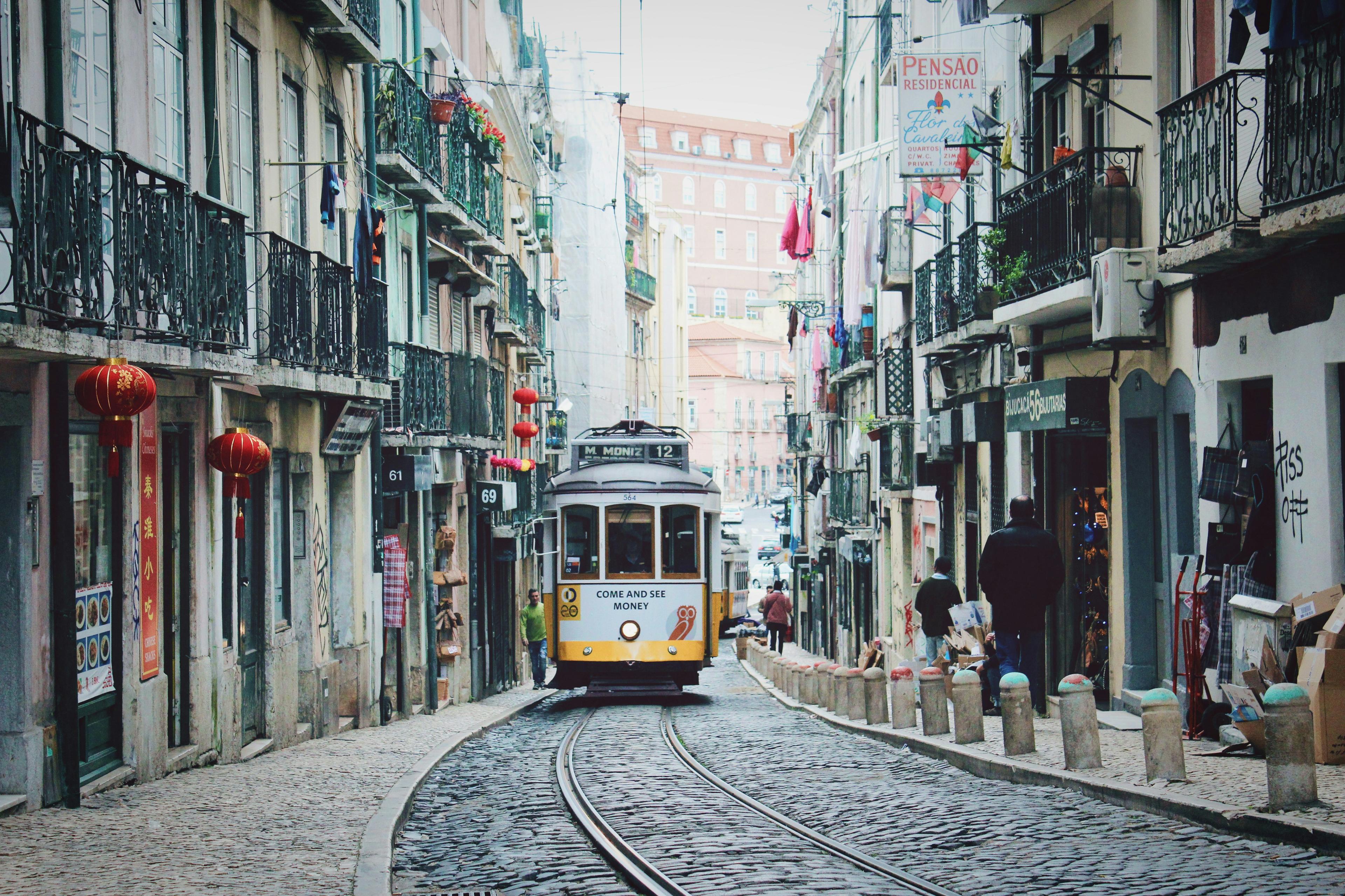 Lisbon tram passing between historic buildings
